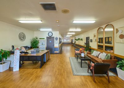 A common room with tables and chairs at Wagner Heights